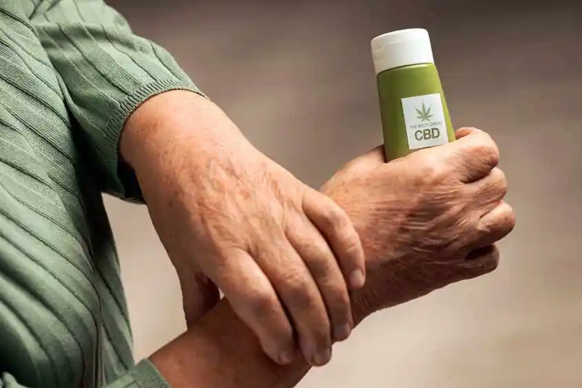 Person applying CBD cream on hands.