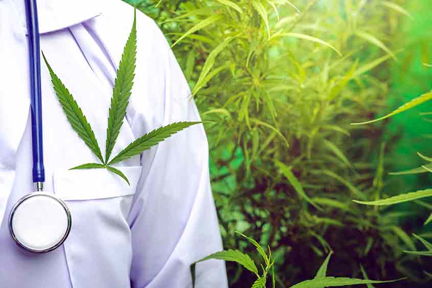 Medical marijuana represented by a white lab coat, a stethoscope and a cannabis leaf in the coat pocket.