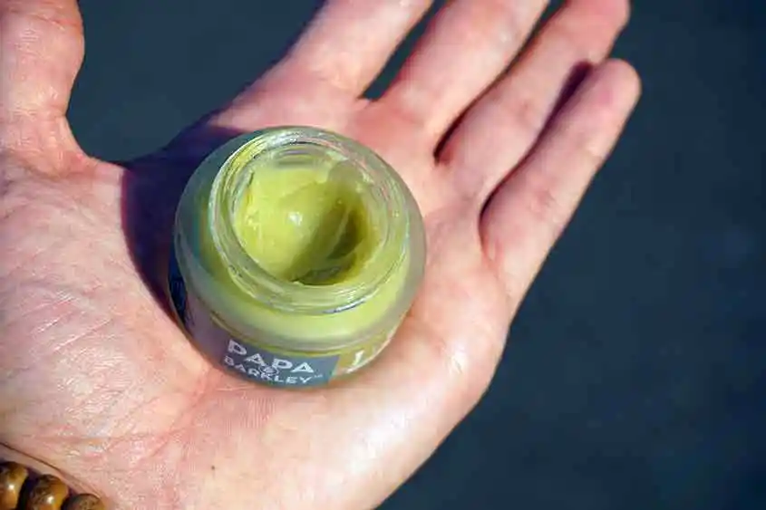 A cannabis topical cream in the pal of a hand